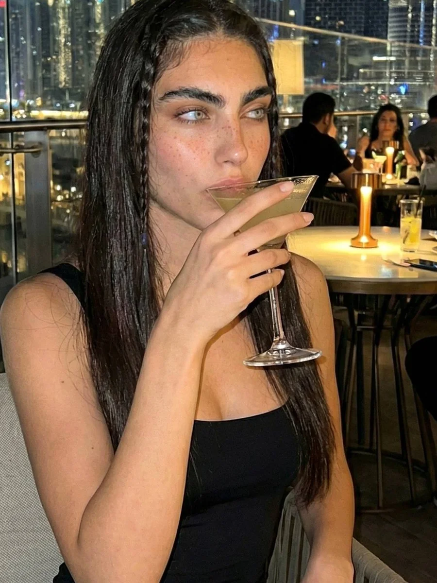 Xara at a candlelit rooftop bar at night